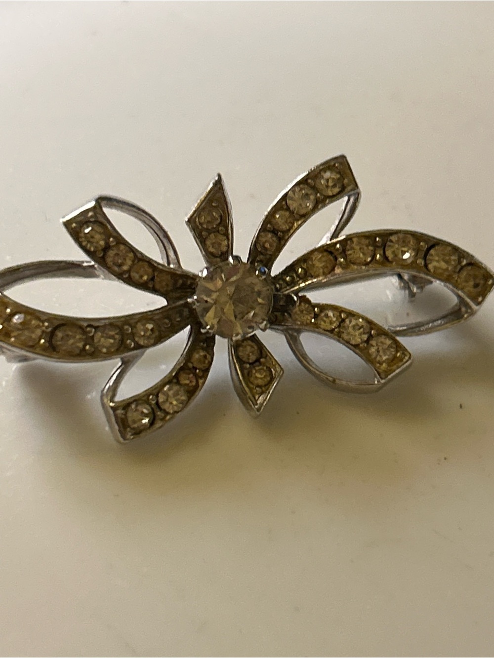 Vintage Crystal Ribbon Bow Brooch – Silver Tone with Champagne Crystals has wear